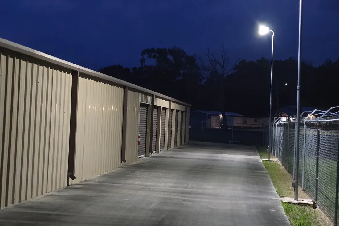 Security-lit drive aisle at night at AAA Vault Storage in Orange, TX